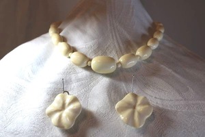 lot 34 image: Sterling silver and bone jewelry Carved bone clip earrings (Marked 925) and graduated elongated bone bead necklace. Screw clasp. 18L