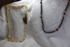 lot 38 image: Silver jewelry (2) Necklaces. Torsade style with Tiger Eye butterfly incorporated pendant 26L and Black bead necklace with push button clasp. 34L. Both marked Silver.