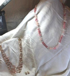 lot 49 image: Jewelry Rose Quartz jewelry selection. Includes triple strand 16L necklace with polished and chip beads, 28L Rose Quartz and faceted glass necklace and post earrings.