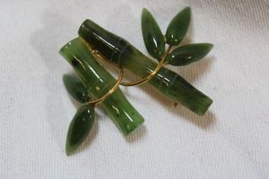 lot 53 image: Spinach Jade 1960s brooch  pin in bamboo form
