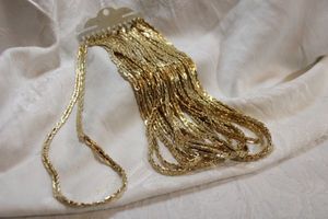 lot 55 image: (12) Gold-plated nugget style chains.16L