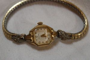 lot 70 image: Bulova 10K Rolled Gold Plate watch with moissanite diamond accents
