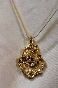 lot 95 image: Nugget style pendant with diamond accent on 18L gold plated chain.