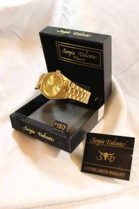 lot 98 image: Sergio Valente gold-tone watch with diamond marker in box.