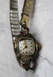 lot 167 image: 10K Rolled Gold Plate Dorlin watch with diamond and Ruby accents. Diamonds and Rubies tested