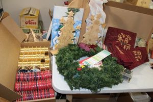 lot 201 image: Christmas decorations ribbons, towels, wood crafts, wreath and more