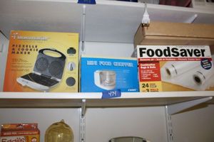 lot 474 image: Kitchen Food saver bags and rolls, mini food chopper, Pizzelle & cookie maker