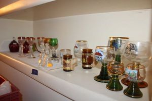 lot 514 image: Colored glass souvenir glasses and lead crystal wine glasses and bells