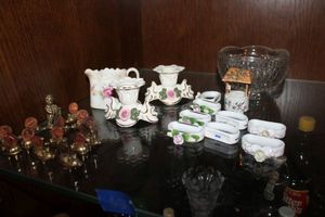 lot 632 image: Porcelain napkin rings and candle holders, brass penny holders and more