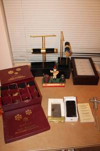 lot 298 image: Jewelry stands, jewelry box, Gold Christmas ornaments, cast iron coin bank, and broken phone