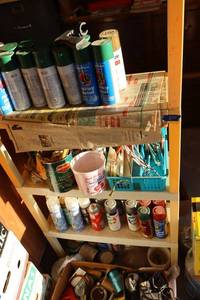 lot 827 image: Spray paint cans and shelf unit