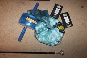 lot 625 image: Golf lot golf balls, VHS tapes, golf ball retriever stick, and AB slider