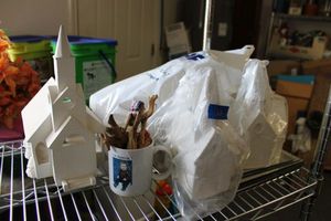 lot 661 image: Unfinished ceramic churches, olive wood figurines, angel tree toppers, and mirrors