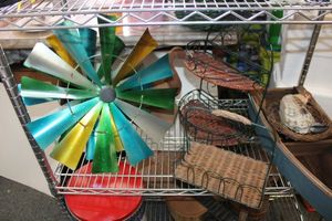 lot 663 image: Home dcor wood boat and duck, wire and basket items, metal wind spinner