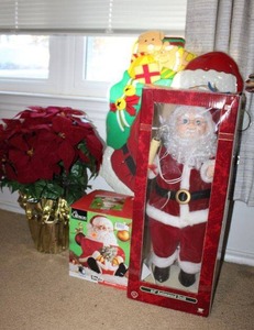 lot 118 image: Santa lot 24 animated Santa, cookie jar, plastic sign and poinsettia plant