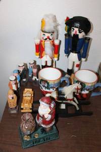 lot 135 image: Wooden figurines, nutcrackers, rocking horse, oversized ceramic mugs, and cast iron Santa coin bank