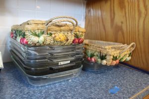 lot 140 image: Pyrex baking dishes and rattan carriers