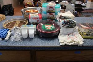lot 171 image: Kitchen towels, cookie cutters, red plastic plates, popsicle molds, Rubbermaid containers and more