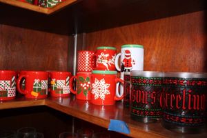 lot 41 image: Red mugs and Seasons Greetings glassware