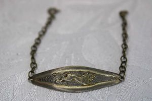 lot 327 image: Sterling Silver cable chain bracelet with European silver (800) center medallion featuring a running big cat. Marked 925 on spring ring and 800 on back of medallion.7.5L