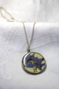 lot 344 image: Sterling Silver necklace (likely Shari Dixon) with artisan crafted dried flower purple Larkspur round pendant. Marked 925 on spring ring clasp. 16L and 2 extender. Pendant 1.25L