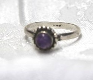 lot 339 image: Sterling Silver ring with bezel set Amethyst round. Marked 925 inside. Size 7.5. Amethyst tested.