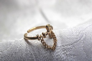 lot 350 image: Sterling Silver vermeil (gold over Sterling) figural cross ring with safety chain. Adjustable size 6. Marked 925 inside