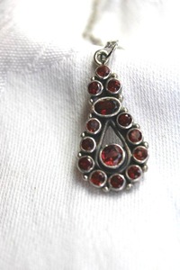 lot 356 image: Sterling Silver Garnet gemstone pendant on Sterling espiga chain necklace with spring ring clasp. Marked 925 on clasp. 18L Pendant also sterling 1.50L