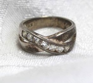 lot 357 image: Sterling Silver bypass ring with channel set crystals. Marked 925 inside. Size 8