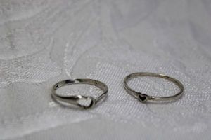 lot 362 image: (2) Sterling Silver rings with open heart focal cutouts. Both marked 925 or Sterling inside. Sizes 7.5 and 5.25