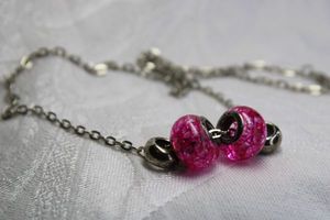 lot 367 image: Silver finish necklace with (2) sterling silver pink slide beads. Both marked 925 on side. 16L