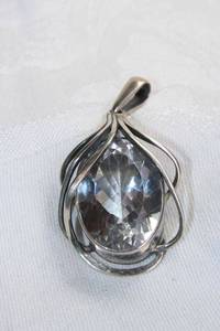 lot 372 image: Sterling Silver large faceted quartz art nouveau style pendant with large bale and open window back mount. Approx 25 x 18mm (43 carats).Marked 925. 2L Quartz tested.