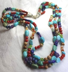 lot 373 image: Sterling Silver triple strand gemstone bead necklace. Marked 925 on extender hang tag. 18L with 3 extender. Lobster clasp. Includes Turquoise, Blue lapis, Jasper, Amethyst, Coral plus