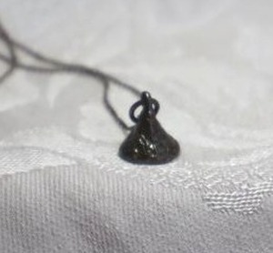 lot 377 image: Sterling Silver foil wrapped Hershey Kiss pendant necklace. Necklace marked 925. 20L with spring ring clasp. Pendant marked JCF 925