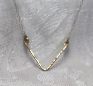 lot 382 image: Sterling Silver necklace with incorporated V shape pendant. 16L with spring ring clasp. Marked 925 on clasp.