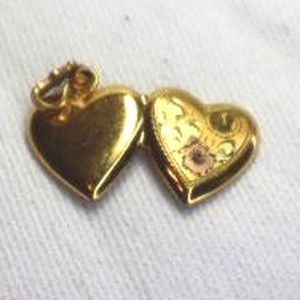 lot 389 image: 12K gold filled heart shape locket with bale.  Marked 120 12K WH inside.