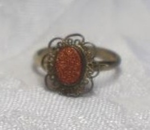 lot 390 image: 12K gold filled adjustable ring with Gold Dust filigree top. Marked 120 12K GF inside band. Adjustable size 5