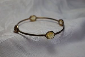 lot 394 image: Sterling Silver vermeil (gold over sterling) bangle bracelet with faceted bezel set Citrine stations. Marked 925