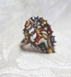 lot 399 image: Sterling Silver multi color prong set oval Sapphire ring. Marked 925. Sapphires tested. Size 7.5.