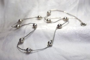 lot 404 image: Sterling Silver liquid bead and round ball station necklace. Spring ring clasp. Marked sterling. 22L