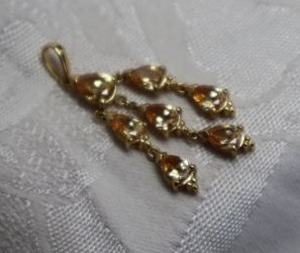 lot 412 image: Sterling Silver vermeil and pear shaped faceted CZ chandelier style dangle pendant. Marked 925 CZ with R hallmark on reverse. 1.75L Large bale.