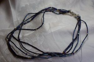 lot 416 image: Signed Sterling Silver Silpada 5-strand Lapis Lazuli tube and other bead necklace. (Needs attention). Has Silpada logo hang tag. Clasp marked 925.