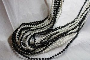 lot 427 image: Black and white classic faceted acrylic multi strand necklace with box clasp. 48L