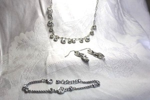 lot 487 image: Rhinestone jewelry. Includes 16L necklace, 7L bracelet and faceted dangle ear wire earrings. 1.25L