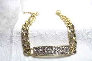 lot 469 image: Cuban link bracelet with rhinestone decorated bar topper. Lobster clasp. Adjustable 7.5-8.5L