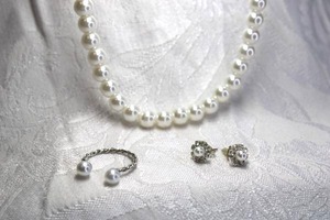 lot 466 image: Classic faux glass pearl necklace. 16L with 2 extender. Lobster clasp. Includes a faux pearl ring and poststud pearl and rhinestone earrings.