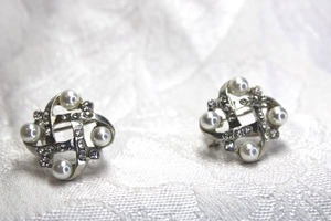 lot 481 image: Silver finish poststud earrings with clip backs decorated with faux pearls and rhinestones and basketweave pattern. 34W