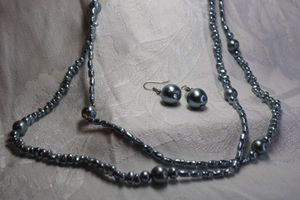 lot 465 image: Grey colored faux pearl continuous necklace with matching large pearl ear wire earrings. 56L. Earrings 1.25L