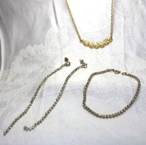 lot 492 image: Gold finish rhinestone tennis bracelet and poststud earrings. Bracelet 6.5L, Earrings 4L Includes a rhinestone necklace. Spring ring clasp. 16L