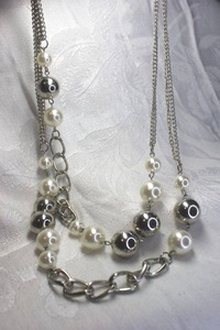 lot 512 image: Silver large ball and faux pearl bead off center necklace with oversize lobster clasp. 22L with 2 extender